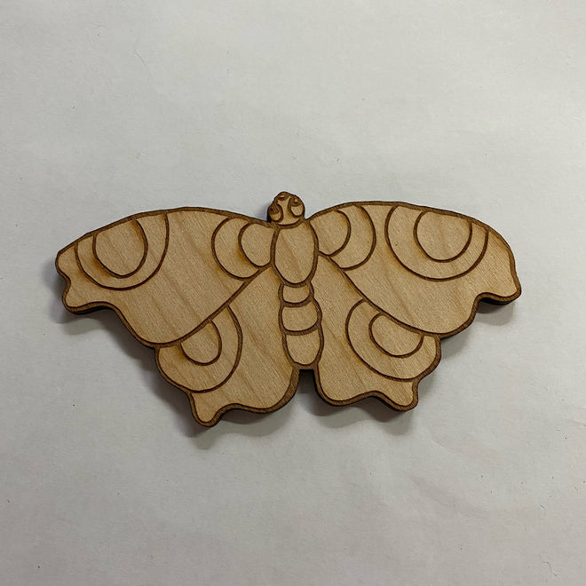 Wooden butterfly-shaped ornament on a white background