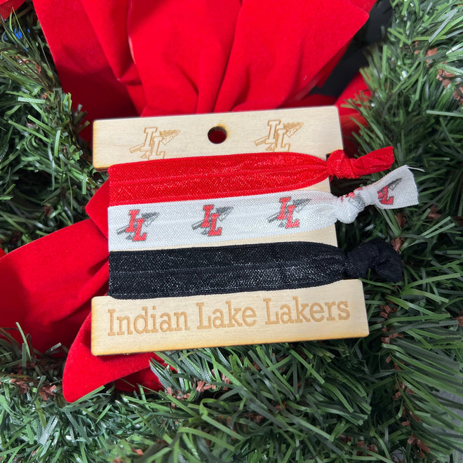 Set of hair ties with branded labels on a Christmas tree.