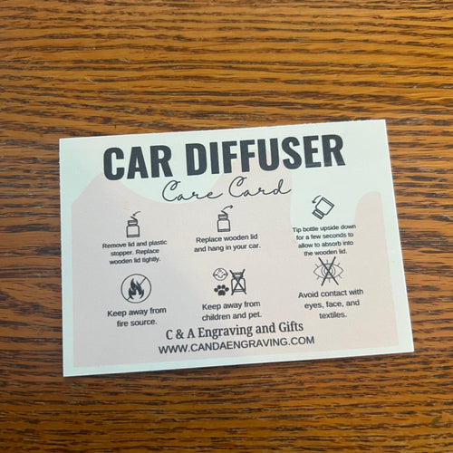Car diffuser card on a wooden surface