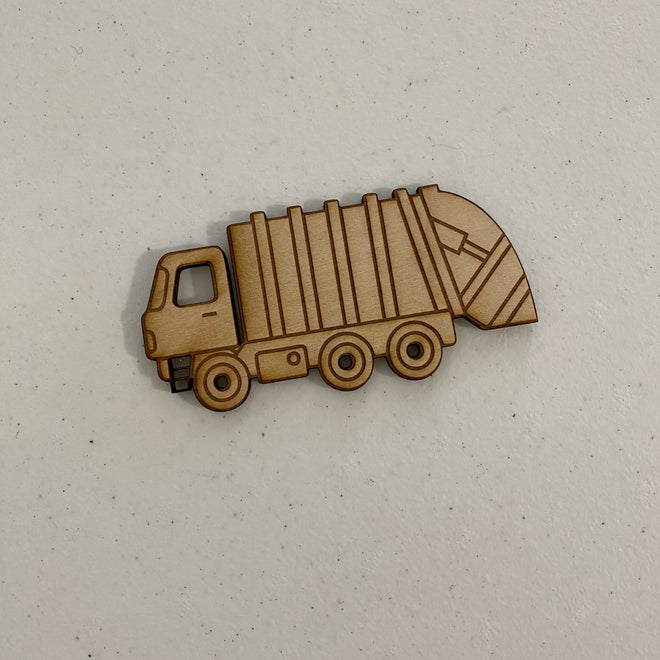 Wooden model of a dump truck on a light gray background