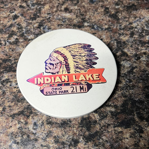 Round sticker with 'Indian Lake' design on a textured surface