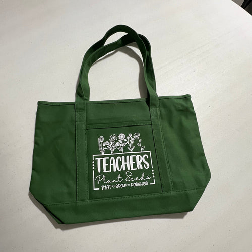 Green tote bag with text on a white surface