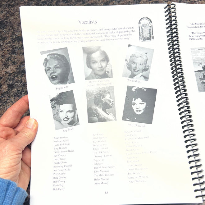 A spiral-bound calendar with black and white images on a textured surface