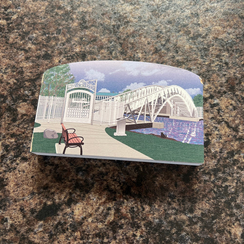 Printed block with a scenic design of a bridge and people on a textured surface