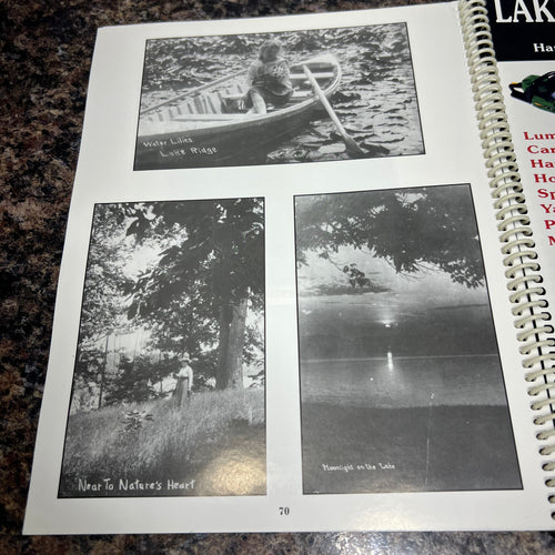 Spiral bound book with black and white photos on a textured surface