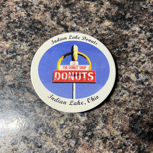 Donut shop coaster on a granite surface