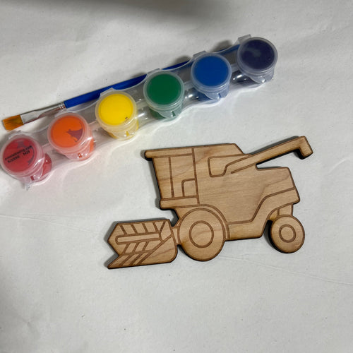 A wooden harvester craft kit on a white background, featuring a laser-cut wooden harvester shape, a small paint palette with multiple colors, and a paintbrush.